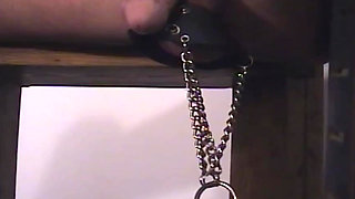 Latex Clad MILF Dominates Her Shackled Male Toy