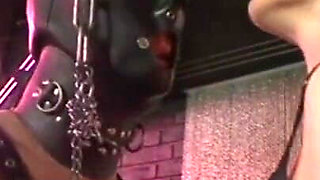 Humiliating man in gas mask