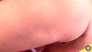 Discover Tammy Jean, a curvaceous MILF with an ample bosom, as she indulges her un-shaved kitty.