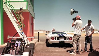 Big tits MILF posing behind the scenes