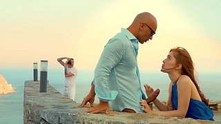 A couple enjoys passionate sex under the open sky with a stunning redhead.