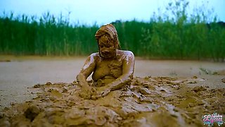 German teen masturbates to orgasm in muddy lake - wet and messy solo fingering