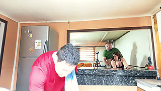 The cuckold is in the kitchen while his friend fucks his unfaithful wife right there.