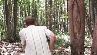 Headphones and tank top tease before she bends over in the woods
