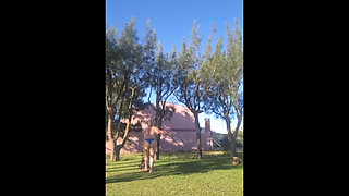 Stepmother in a Bikini in the Garden of the House Makes a Video for Her Stepson, to Show off Her New Clothes.