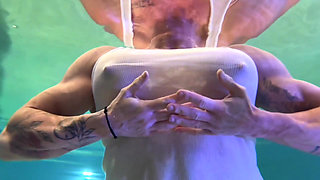 Amazon Kandy Flexes Her Massive Biceps in Her Hotel Pool