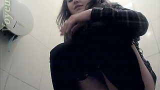 Beautiful and young brunette sees camera and pisses in the toilet room