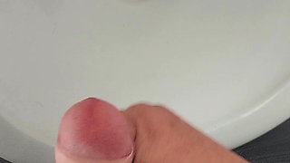 Moaning daddy has a lot of pressure and milks his cock in the public toilet