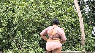 A Full-figured Woman in a White Skirt and Pink Top Strips Down and Walks Nude Outside
