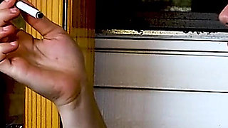 Shaved Head Goth Smokes Outside