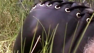 Herrin enslaves man and enjoys foot fetish outdoor