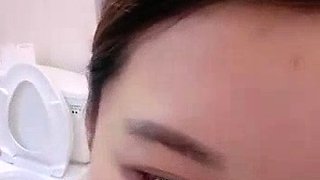 Asian babe sucking and jerking two hard dicks